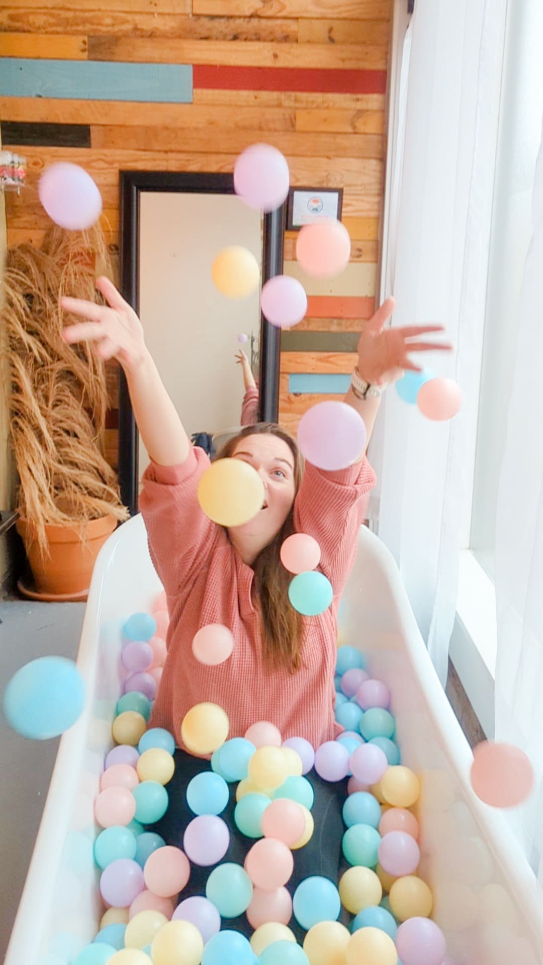 Woman throws pastel balls into the air