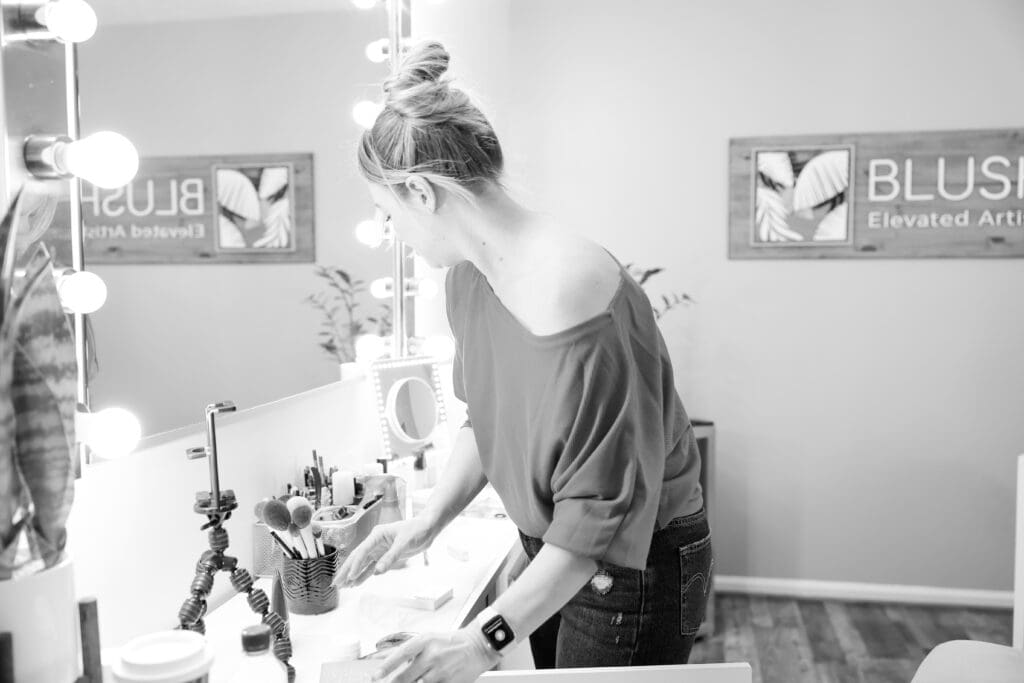 Black and white photo of a make up artist prepping her studio | Why small businesses need brand photos