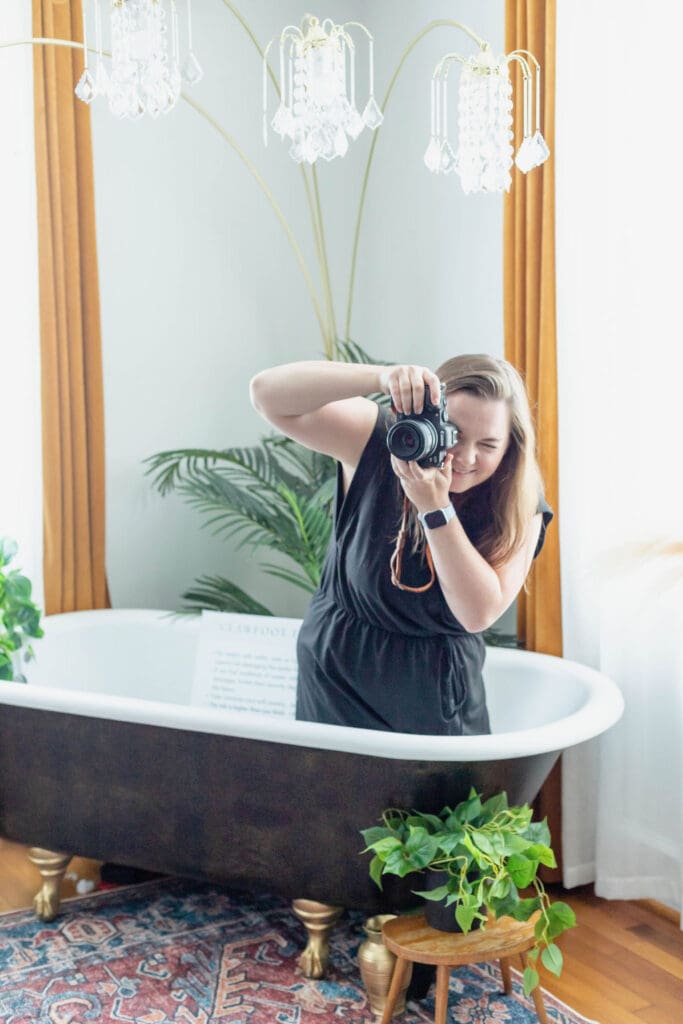 Photographer kneels in bathtub to get the perfect photo | What to Wear for Your Brand Photos